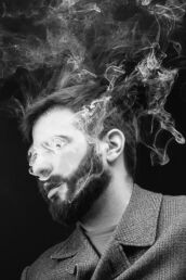 a black and white image of a man vaping from a portrait session in north London. Photograph by Siorna Ashby