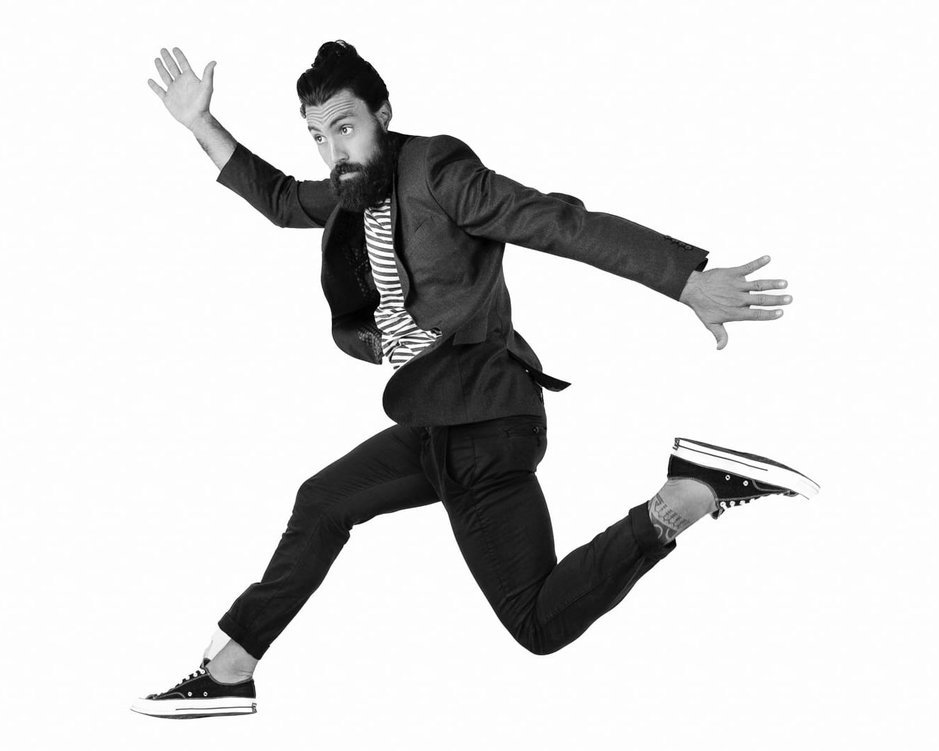 London branding headshot photograph of a man jumping on a white background