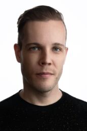 a male London headshot photo with white background and black t shirt