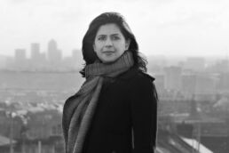 A black and white London headshot photo of a woman's photoshoot with the city of London in the background