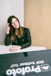 A behind the scenes photoshoot of a London portrait photographer with woman in a leather jacket.