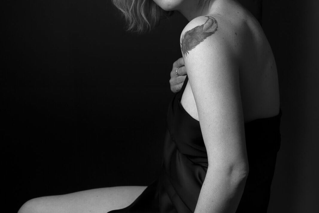 how to prepare for a boudoir photoshoot with a woman in a silk scarf and tattoo
