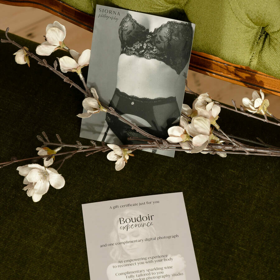 a boudoir gift card on a green couch with flowers