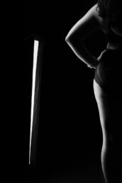 a body silhouette of the female form lit with a studio light from a london boudoir photography studio session