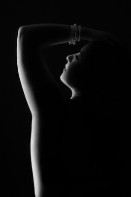 a woman's silhouette with bracelets in black and white from a London boudoir photography photoshoot