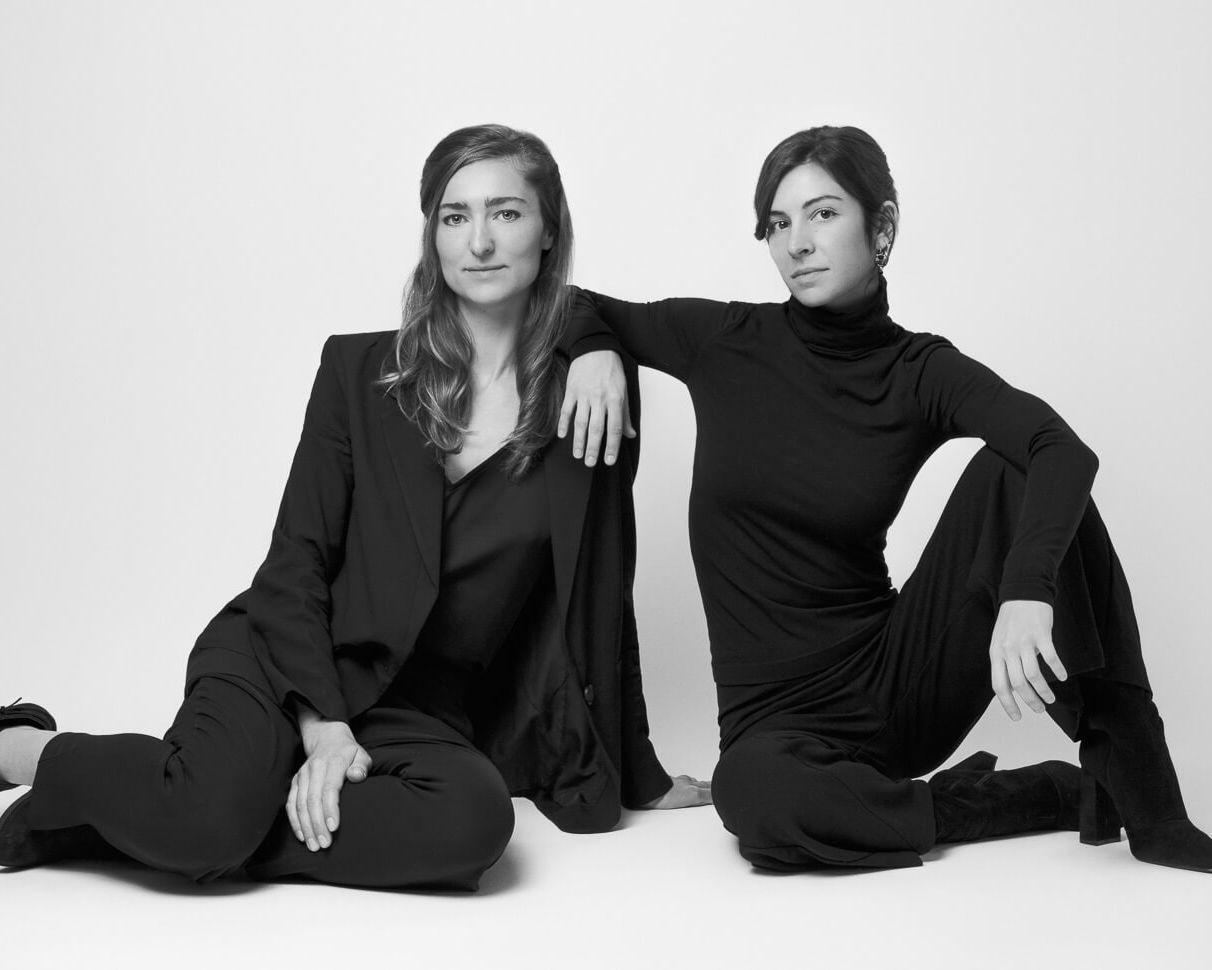 two women in suits sitting on the floor on a london headshot photography photoshoot