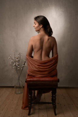 photography of lady in a chair looking sidewards