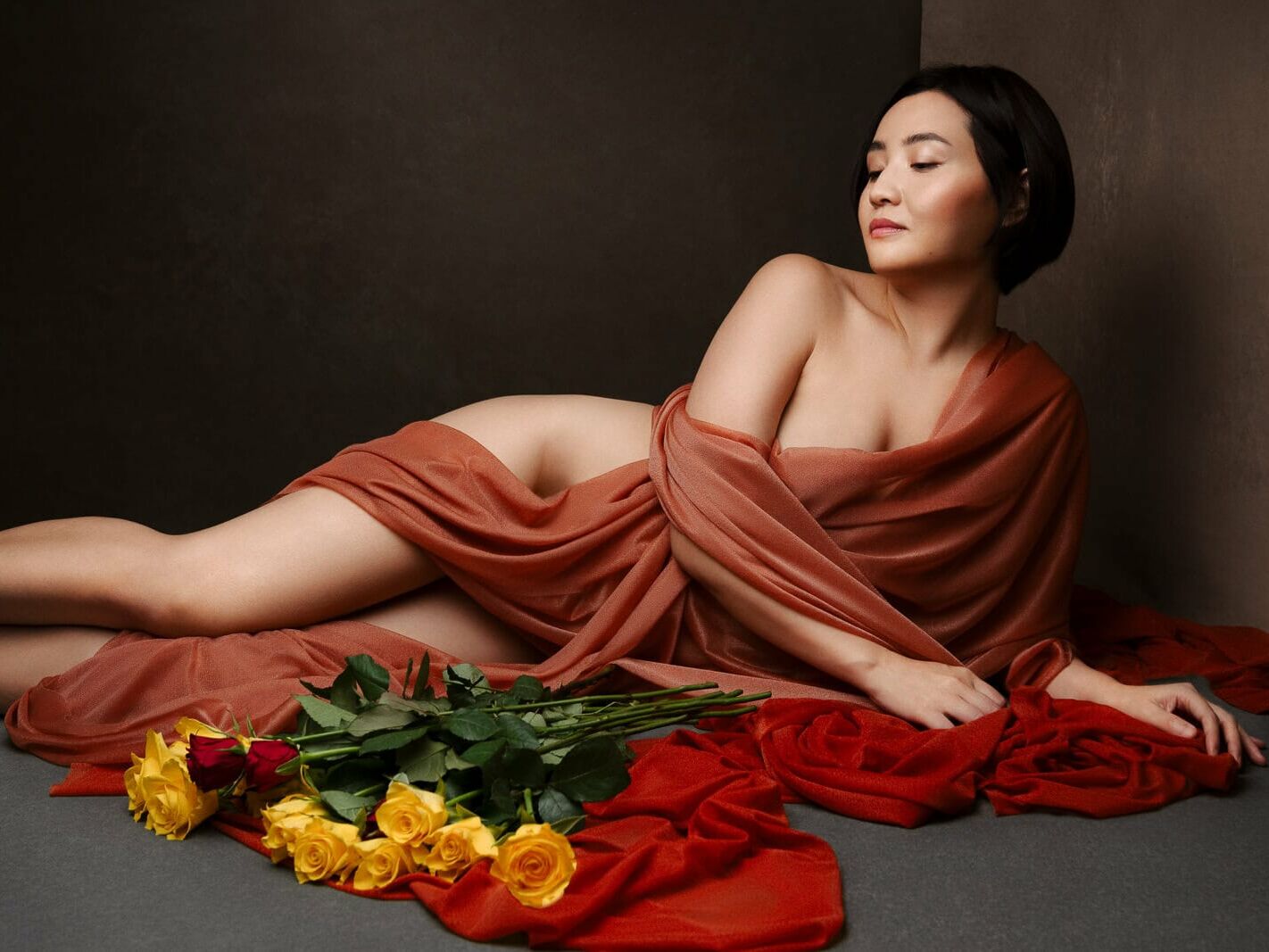 a south asian woman in silk with yellow roses from boudoir shots in London