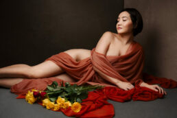 a south asian woman in silk with yellow roses from boudoir shots in London