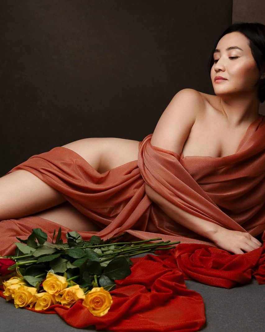 a south asian woman in silk with yellow roses from boudoir shots in London