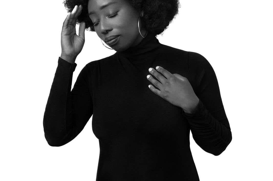 a black woman wearing a body suit as a boudoir photoshoot outfits idea.