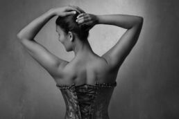 An indian woman in a corset on a boudoir photoshoot in London