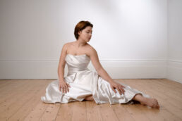 a woman in a wedding dress on a bridal boudoir photography photoshoot