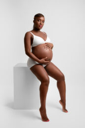a black woman in white lingerie on a London maternity photography photoshoot