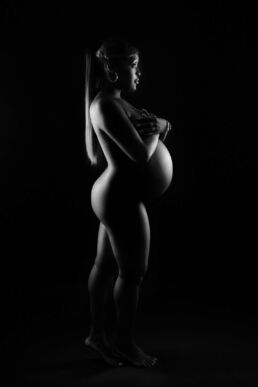 a black woman with jewellery and light silhouette on a London maternity photography photoshoot
