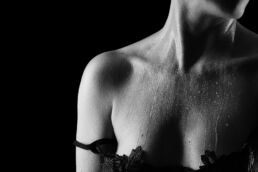water droplets running down skin with a bra on a boudoir photography uk photoshoot