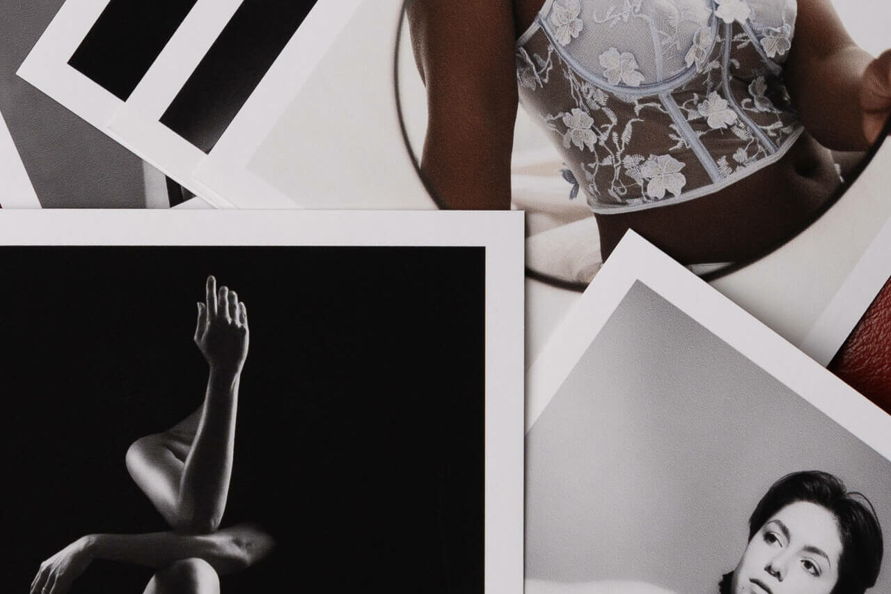 boudoir pictures scatterd on the floor as postcards