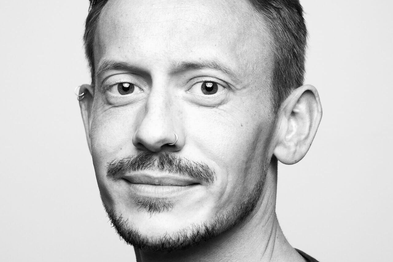 A high contrast black and white male headshots in London with a beard in black and white