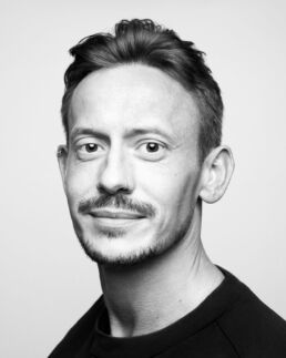A high contrast black and white male headshots in London with a beard in black and white