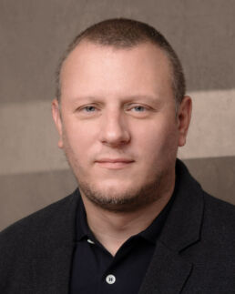 a museum director headshot with a canvas background taken by a london headshot photographer