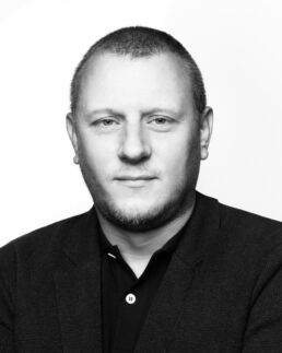 A high cntrast black and white headshot taken by a london headshot photographer