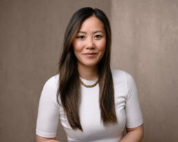 An asian woman in a white shirt and gold chain taken by a london headshot photographer