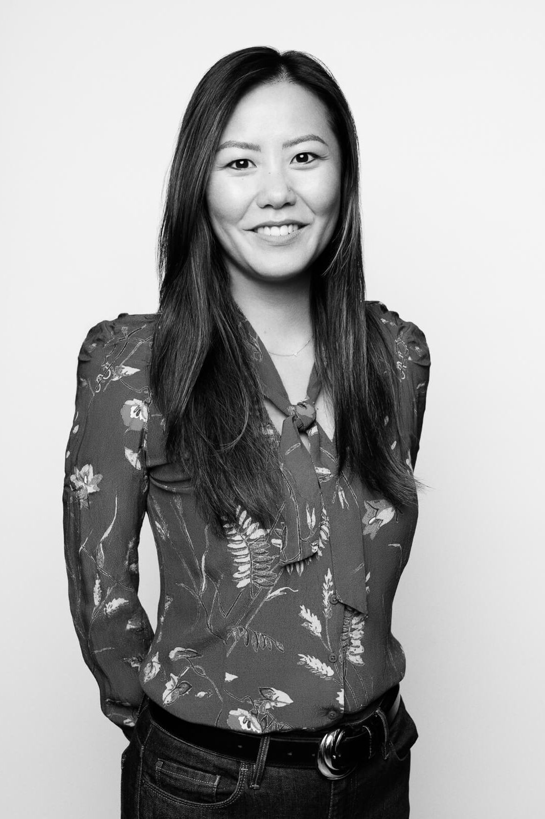 An Asian woman in a floral shirt in black and white from a London Headshot Photographer
