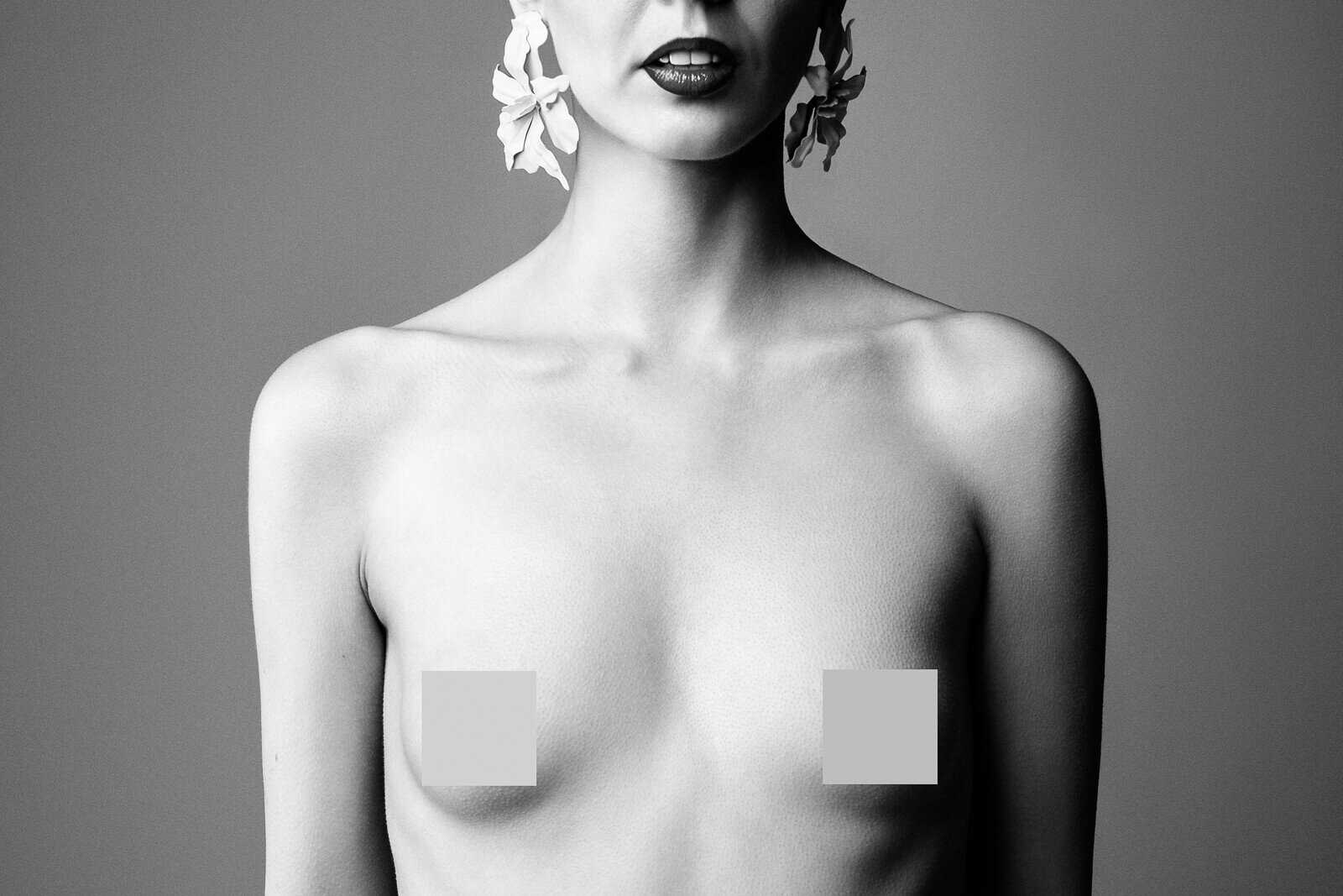 A high-contrast monochrome study exploring tone and texture, where light defines confidence rather than contour.