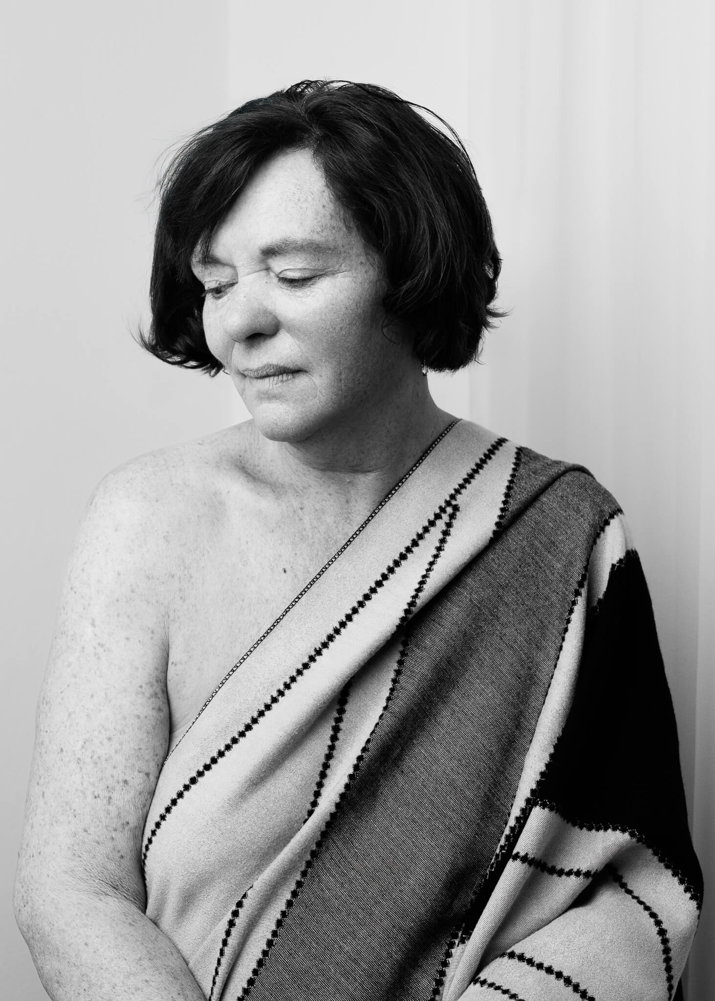 Timeless black and white boudoir photo of an older woman celebrating femininity and self-worth
