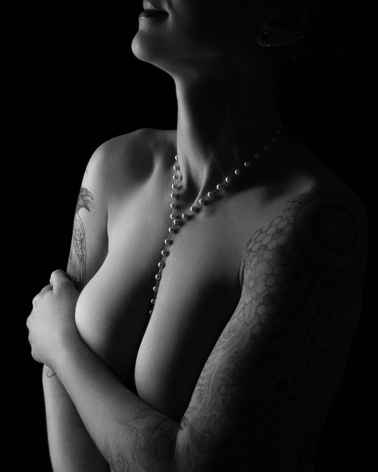 Content creator boudoir photographer London — with body pearls and dark sultry lighting