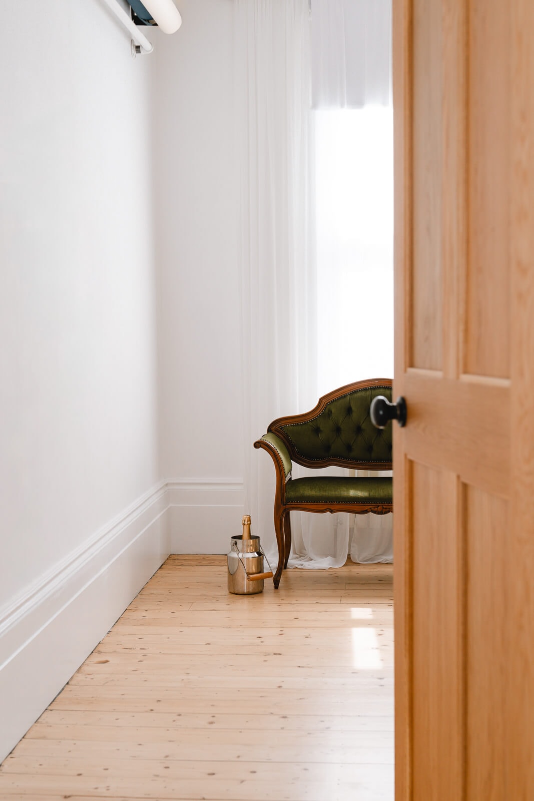 Elegant wooden floors and natural light with vintage chairs and sparkly wine inside my London boudoir studio.