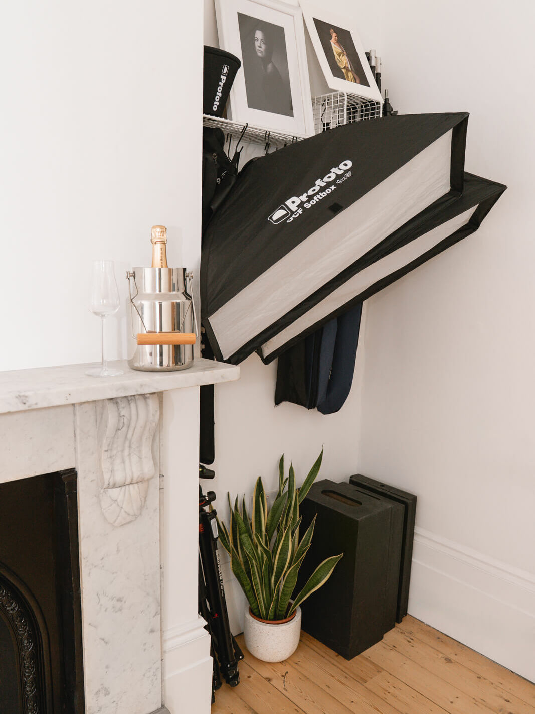Professional studio setup with lighting, a mantlepiece, and sparkling wine — elegant details inside my London boudoir studio