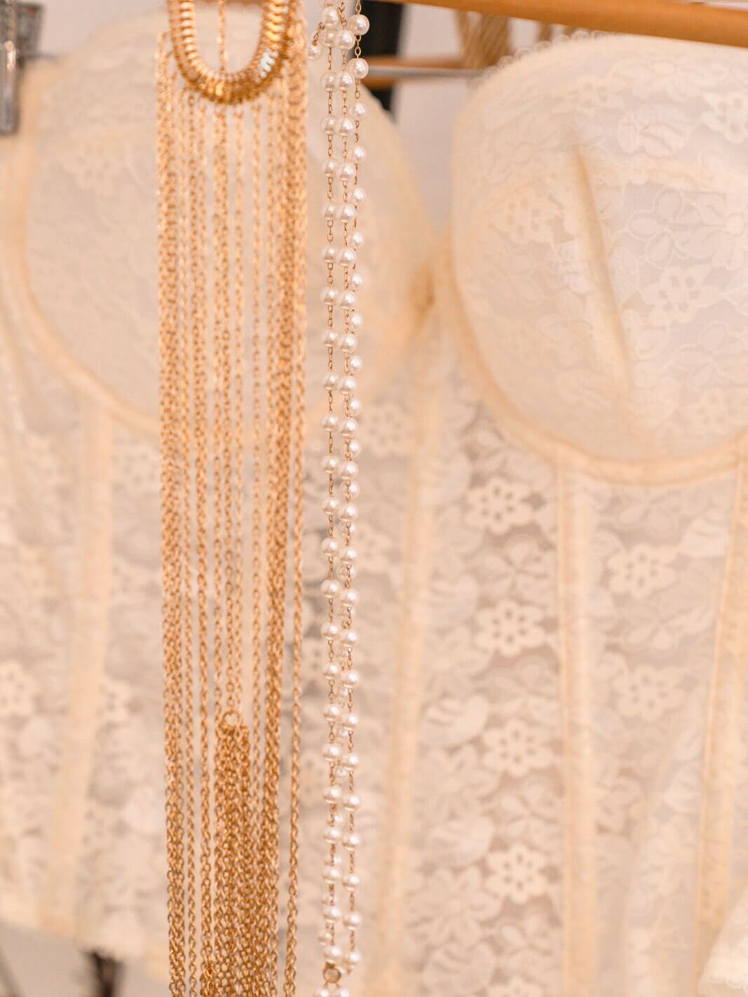 Close-up of an ornate corset, pearls, and a body chain — styling details inside my London boudoir studio