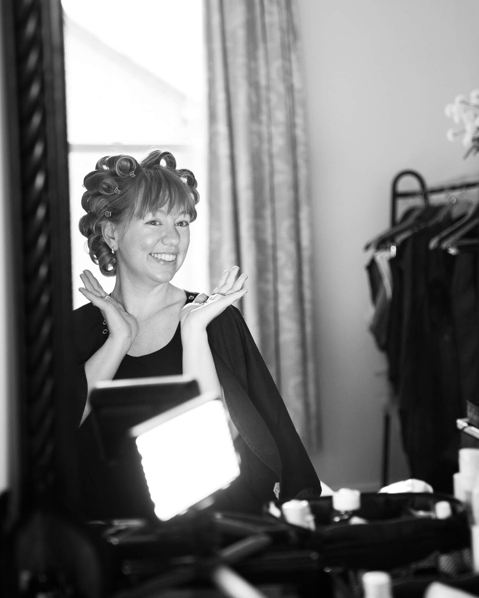 Woman smiling during hair and makeup before her boudoir photoshoot in a private London studio.