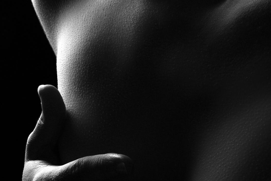 Dark and sultry boudoir photograph in London studio, silhouette in soft shadow