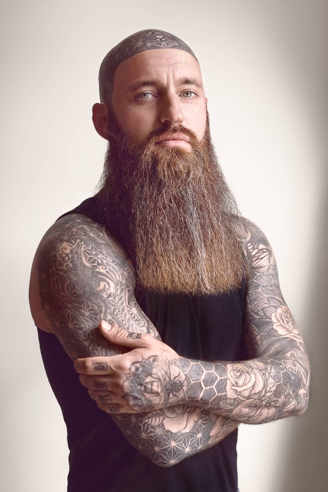 Bearded man in a vest photographed as a creative studio portrait in London