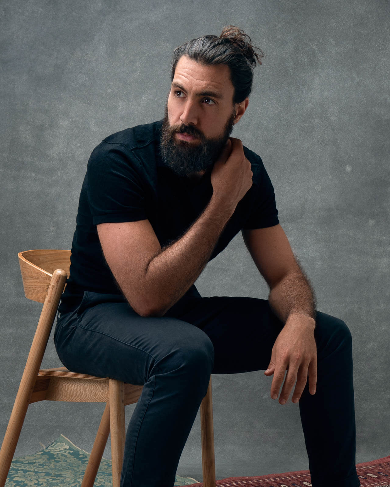 Cinematic, moody studio portrait of a bearded man in London