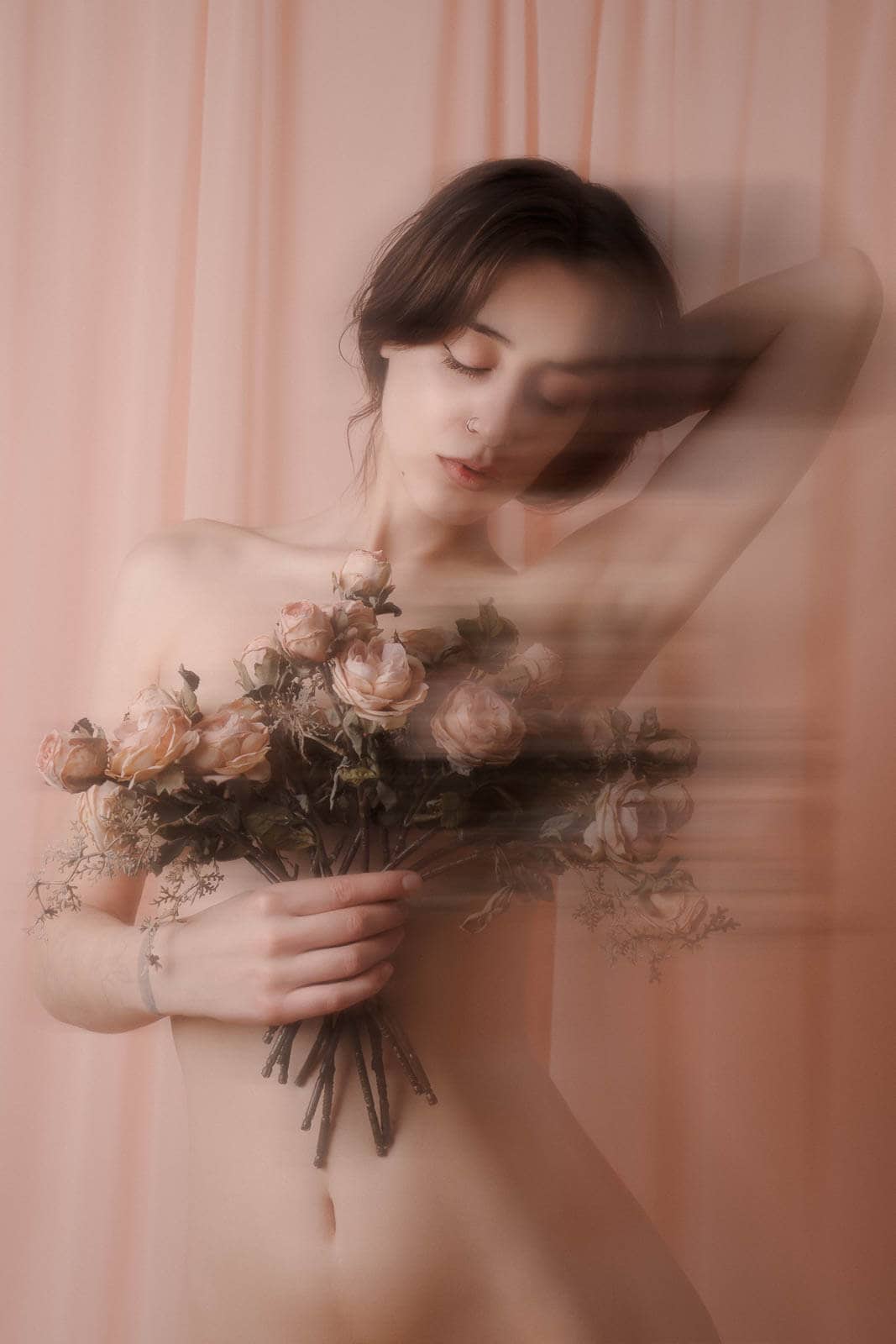 Romantic boudoir portrait with pink drapery and roses for boudoir photography styles by mood.