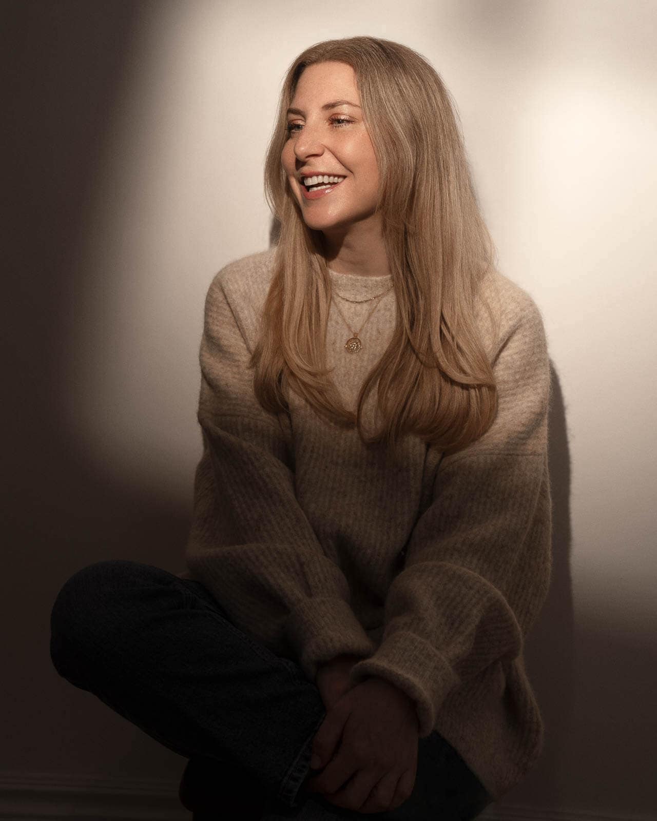 Natural studio portrait of a smiling woman by London portrait photographer Siorna Ashby